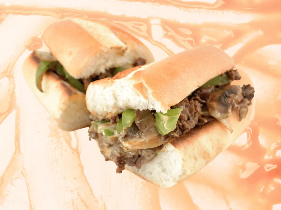 Steak Philly with green peppers, mushrooms and melted cheese on a toasted roll